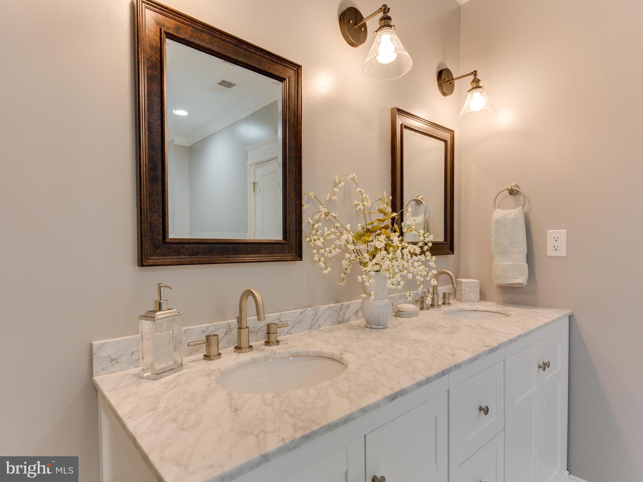 3722 Chesapeake Street Northwest Washington, DC 20016 - Photo 16 of 30 a bathroom with a granite countertop sink and a mirror
