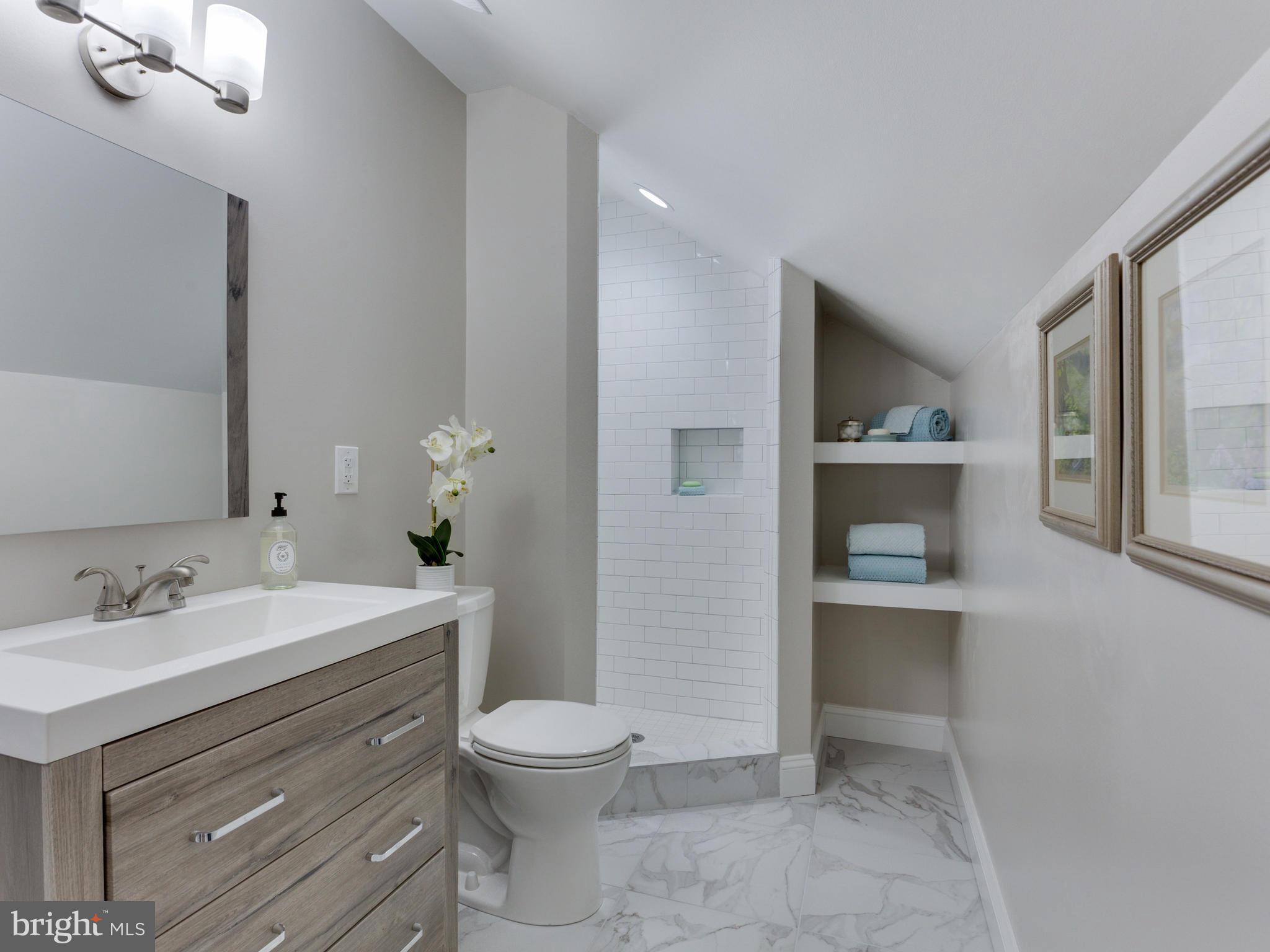 3722 Chesapeake Street Northwest Washington, DC 20016 - Photo 21 of 30 a bathroom with a sink a toilet and mirror