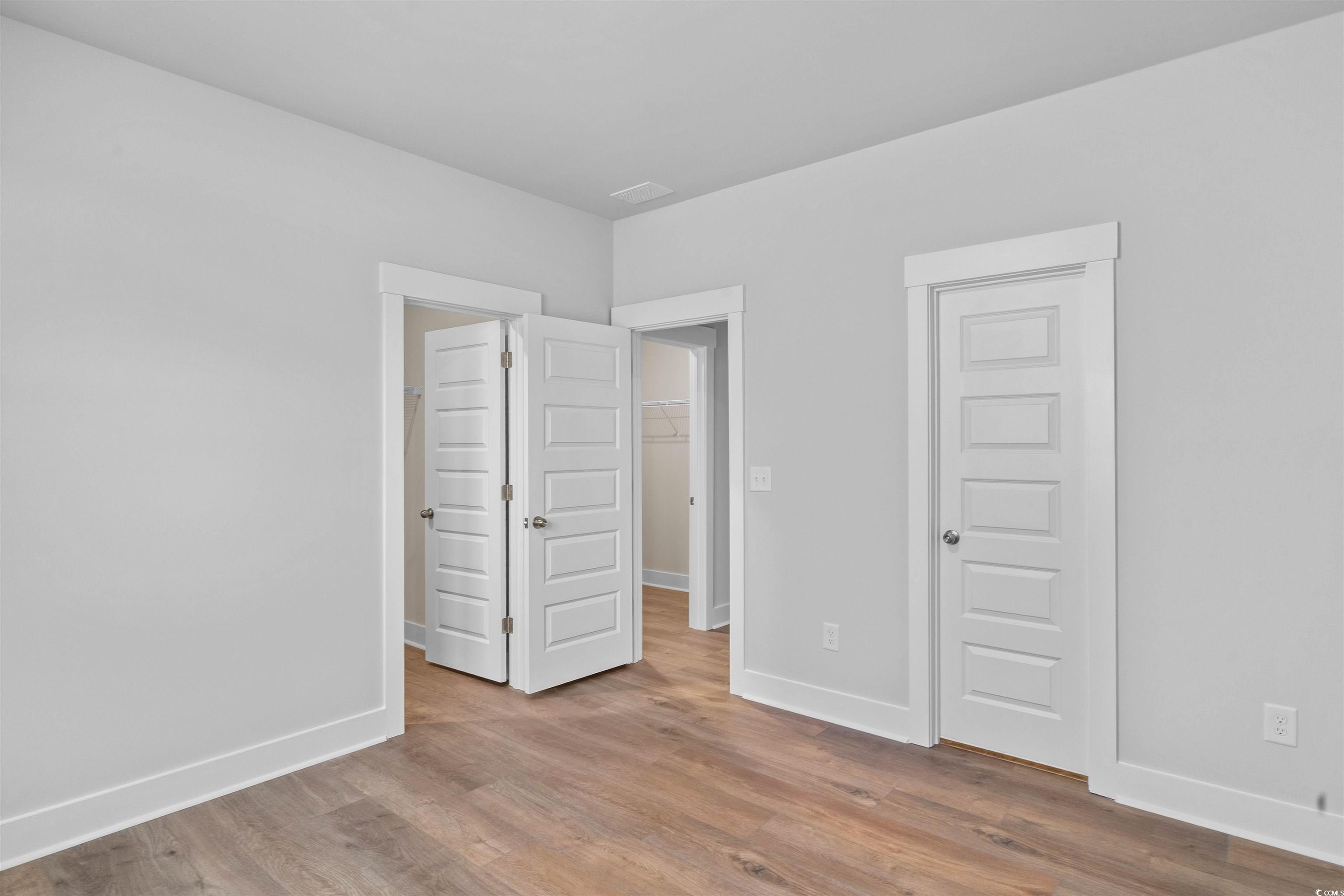 224 Atlantic Breeze Street Myrtle Beach, SC 29572 - Photo 11 of 39 Unfurnished bedroom featuring wood finished floors and baseboards