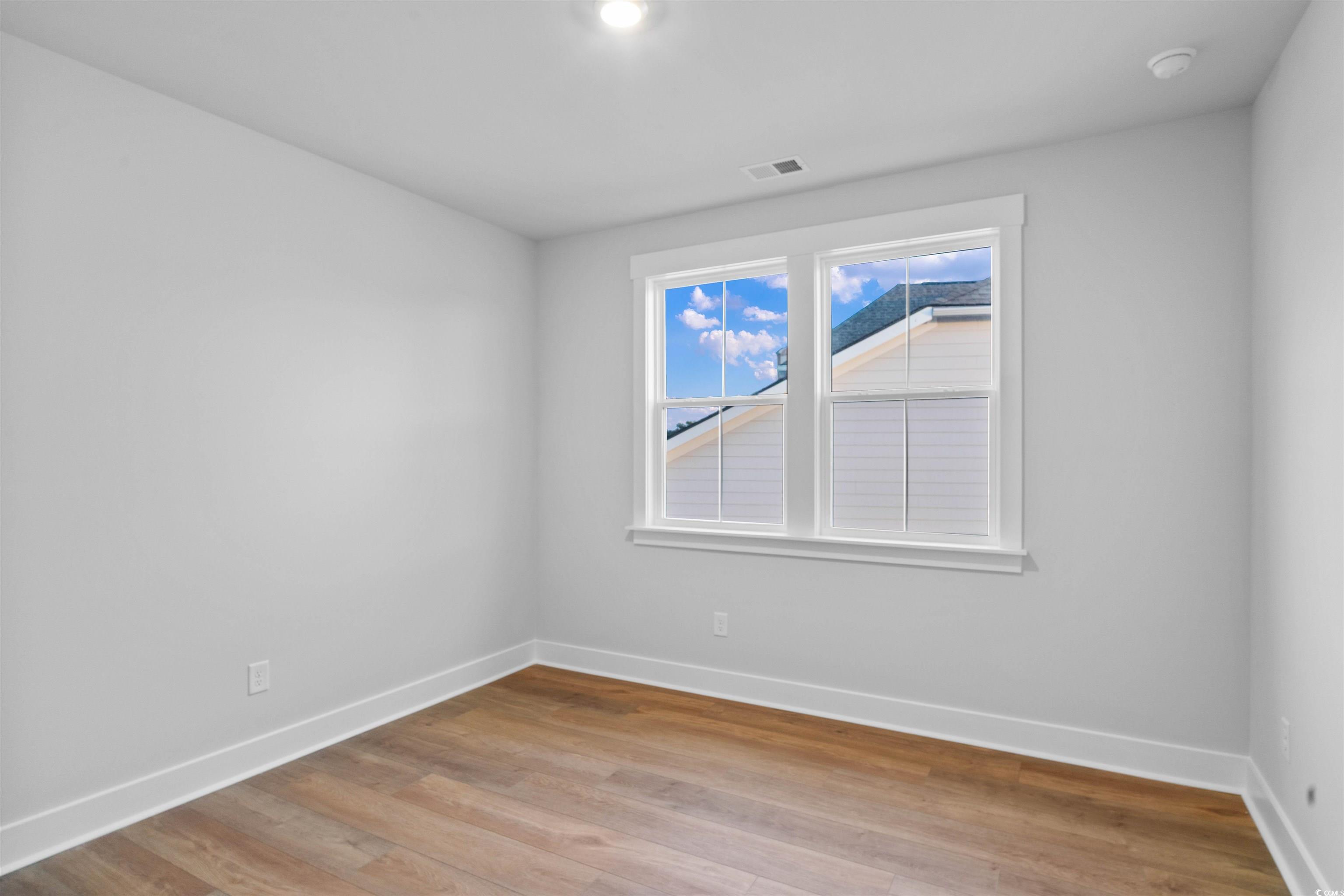 224 Atlantic Breeze Street Myrtle Beach, SC 29572 - Photo 12 of 39 Empty room with baseboards and light wood finished floors