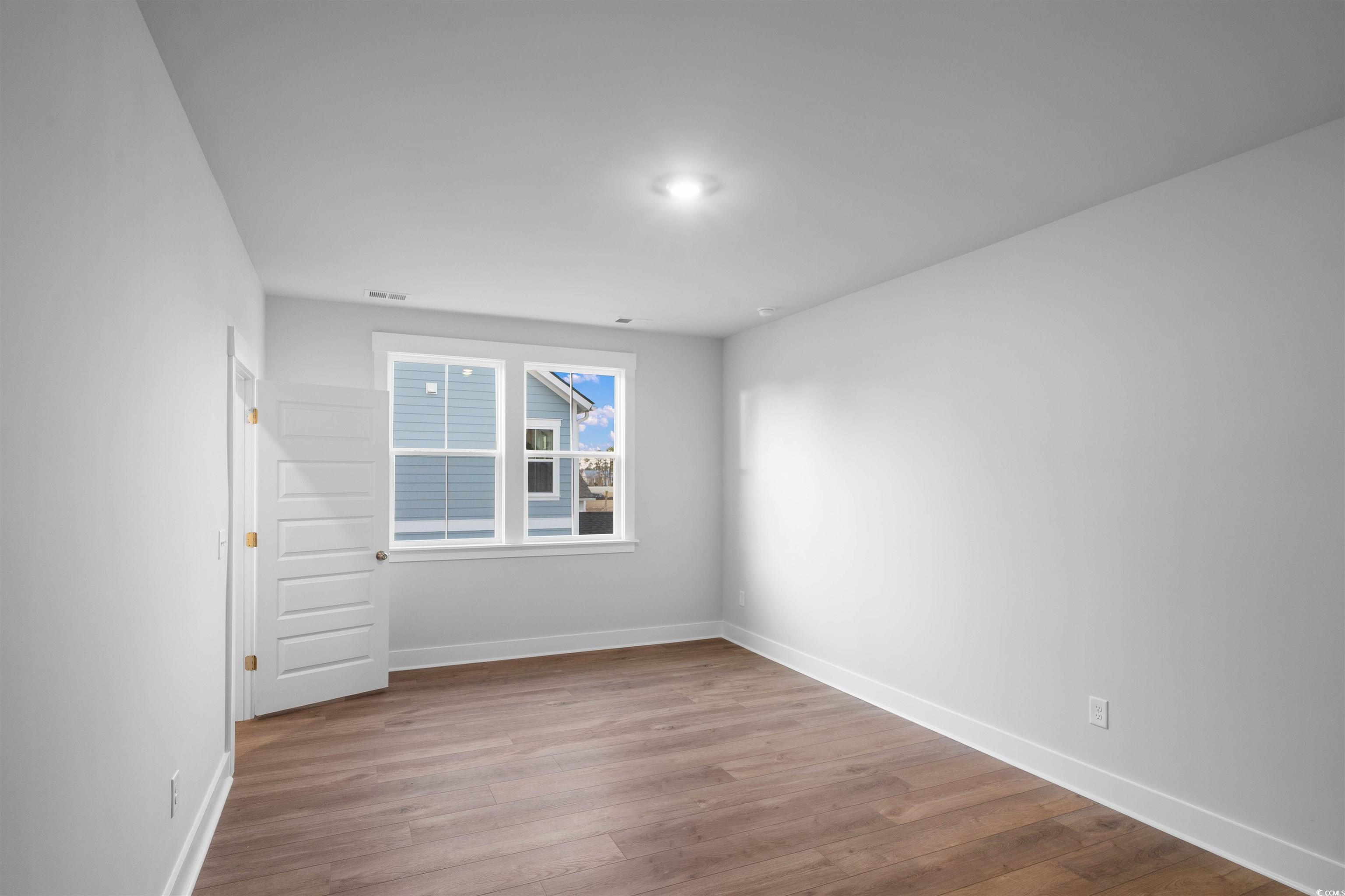 224 Atlantic Breeze Street Myrtle Beach, SC 29572 - Photo 13 of 39 Spare room featuring wood finished floors and baseboards