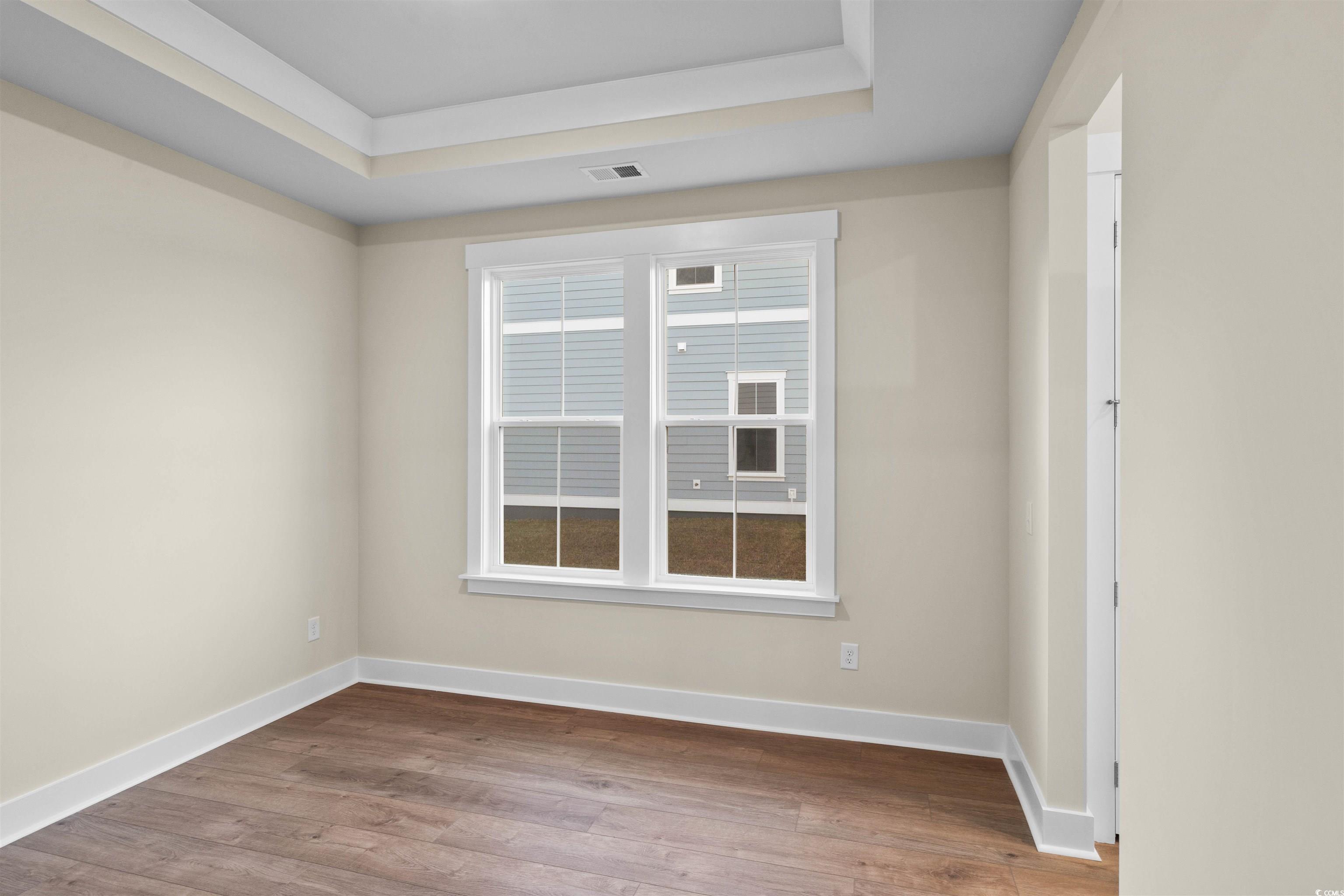 224 Atlantic Breeze Street Myrtle Beach, SC 29572 - Photo 18 of 39 Unfurnished room with a raised ceiling and wood finished floors