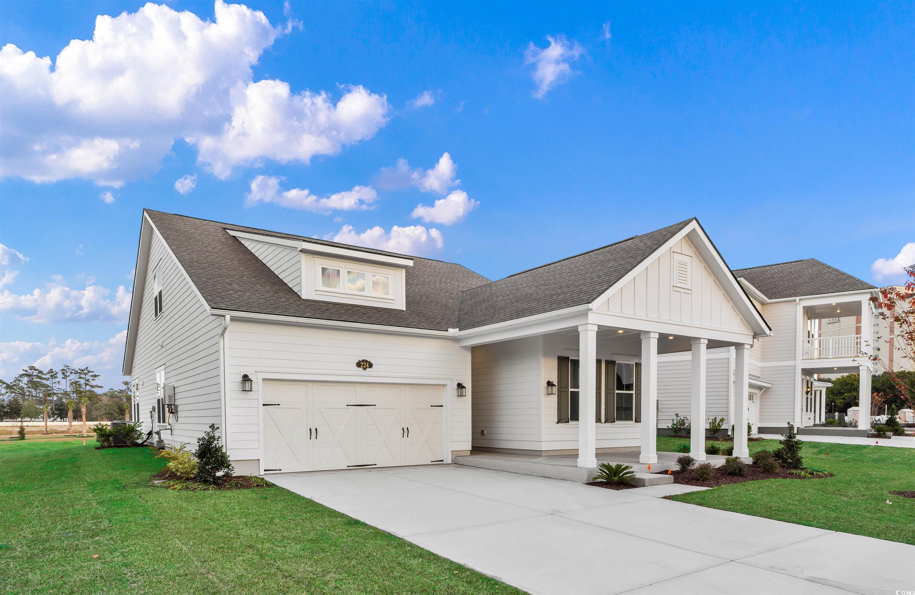 224 Atlantic Breeze Street Myrtle Beach, SC 29572 - Photo 4 of 39 Modern farmhouse featuring roof with shingles, a front yard, concrete driveway, and a garage
