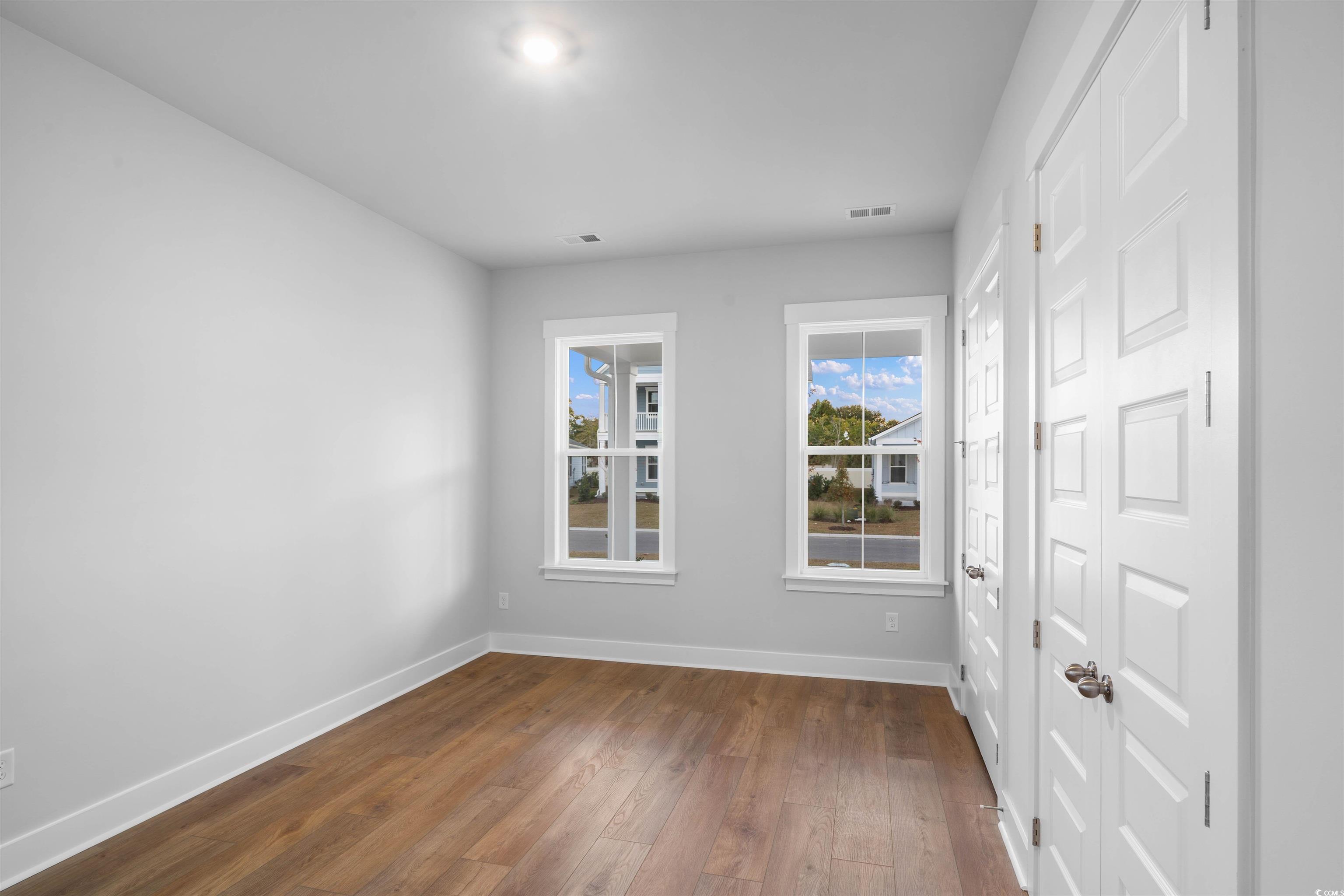 224 Atlantic Breeze Street Myrtle Beach, SC 29572 - Photo 7 of 39 Empty room with baseboards and dark wood-style floors