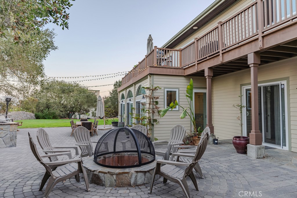 755 Willow Road Nipomo, CA 93444 - Photo 13 of 43 Entertainers dream back yard with built in custom fire pit - adjacent to the sliding glass doors that lead to the indoor pool and spa area plus large bonus room with kitchenette and bathroom