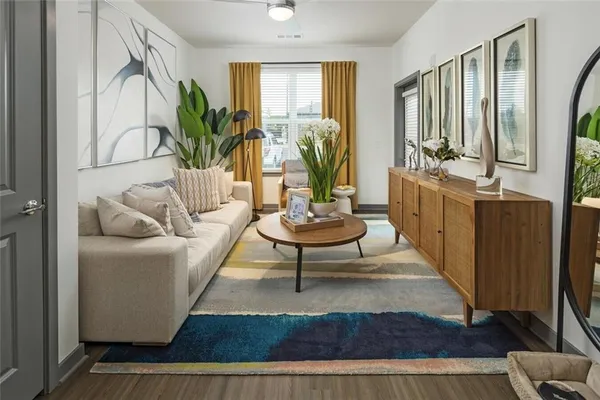 a living room with furniture flowerpot and a potted plant