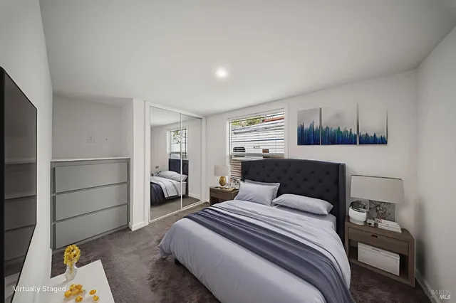 an empty room with windows and closet