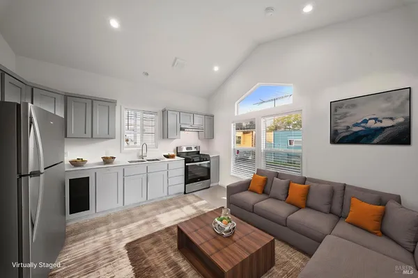 a kitchen with granite countertop a refrigerator and a stove top oven