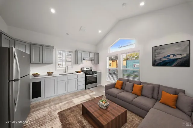 a kitchen with granite countertop a refrigerator and a stove top oven