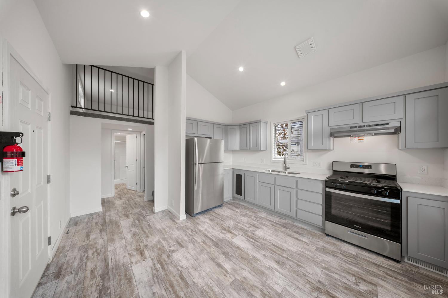 742 Francisco Boulevard West, Unit B12 San Rafael, CA 94901 - Photo 8 of 16 a kitchen with granite countertop a refrigerator and a stove top oven