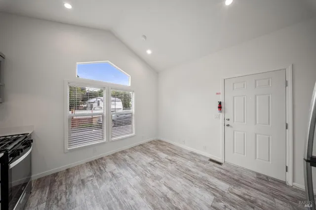 a kitchen with a refrigerator and a stove top oven