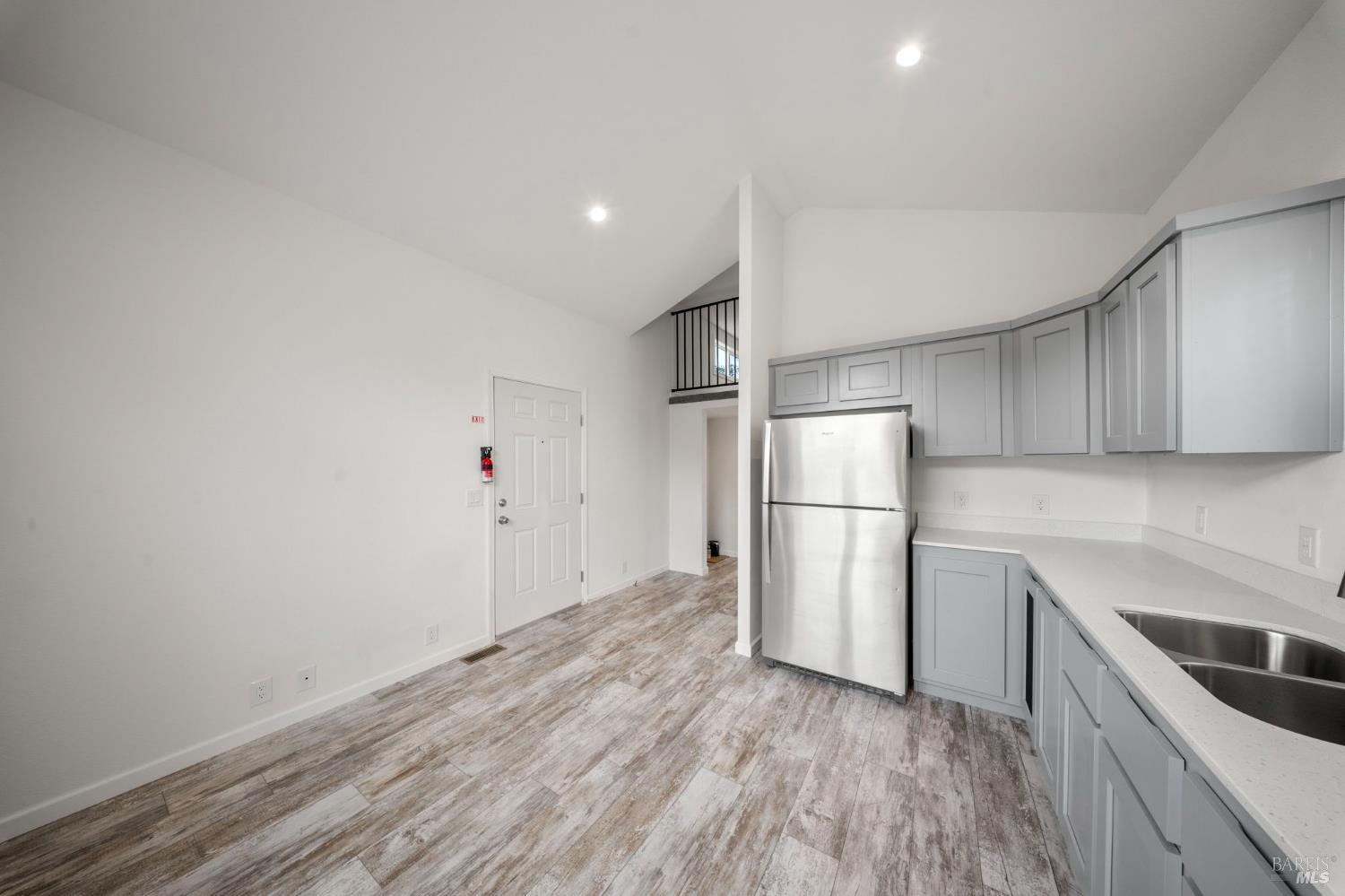 742 Francisco Boulevard West, Unit B12 San Rafael, CA 94901 - Photo 10 of 16 a kitchen with a refrigerator and a stove top oven