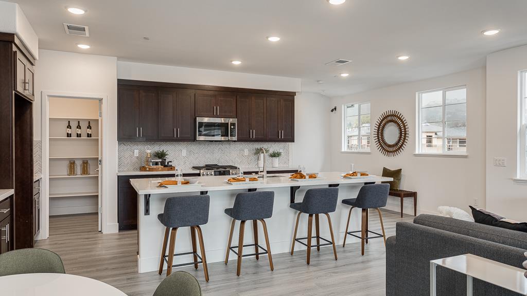 338 Line Street Hayward, CA 94544 - Photo 11 of 25 a living room with stainless steel appliances kitchen island granite countertop a dining table chairs and a refrigerator