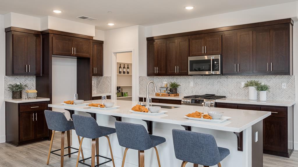 338 Line Street Hayward, CA 94544 - Photo 13 of 25 a kitchen with stainless steel appliances a stove a sink a microwave a refrigerator and chairs