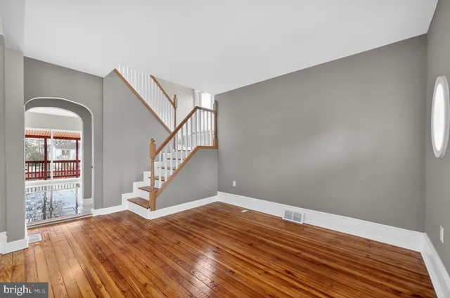 a view of entryway and hall with wooden floor