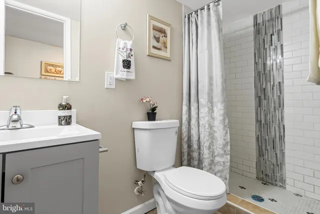 a white toilet sitting next to a bathroom sink