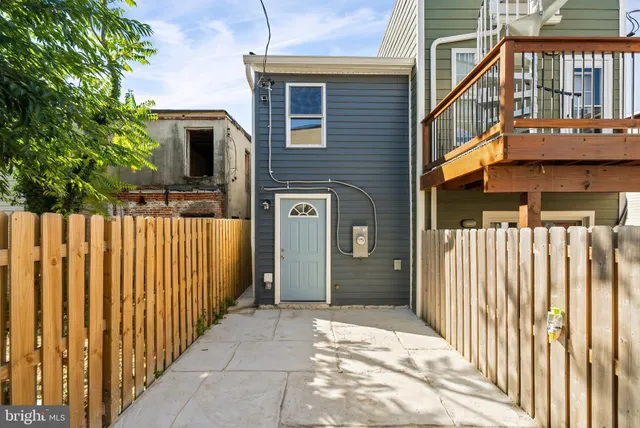 a view of a house with wooden fence