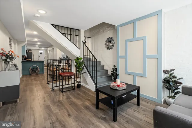 a living room with furniture and a wooden floor
