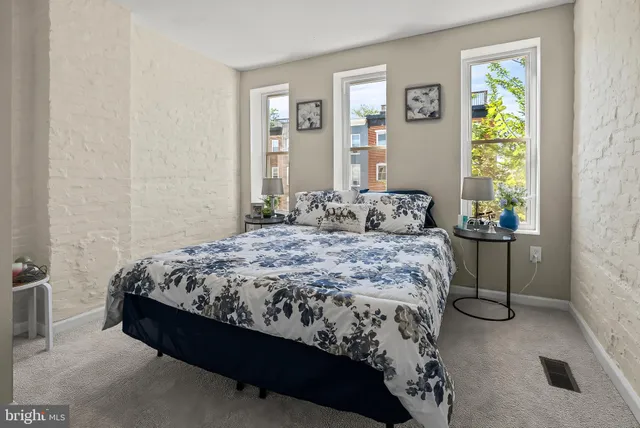 a bedroom with a bed and with windows