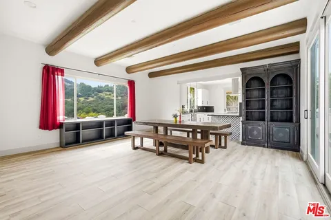 a open kitchen with stainless steel appliances granite countertop a stove and a refrigerator