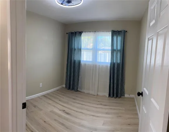 a view of a room with a wooden floor and a window