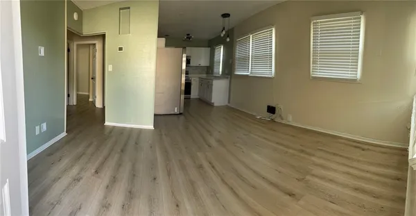 a view of a livingroom with wooden floor and a window