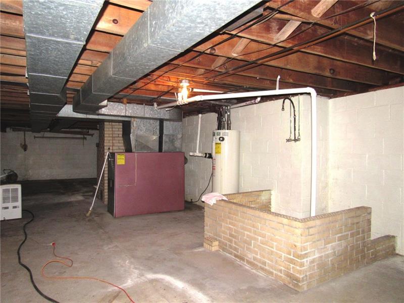 164 County Line Road Acme, PA 15610 - Photo 22 of 25 Family says this shower was used on a regular basis when they were growing up. The furnace was just serviced and all is good! Beyond the furnace is the second fireplace.