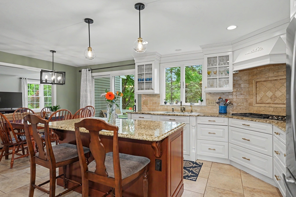 15 Lanthorn Road Northborough, MA 01532 - Photo 9 of 37 a kitchen with stainless steel appliances granite countertop a table chairs and white cabinets