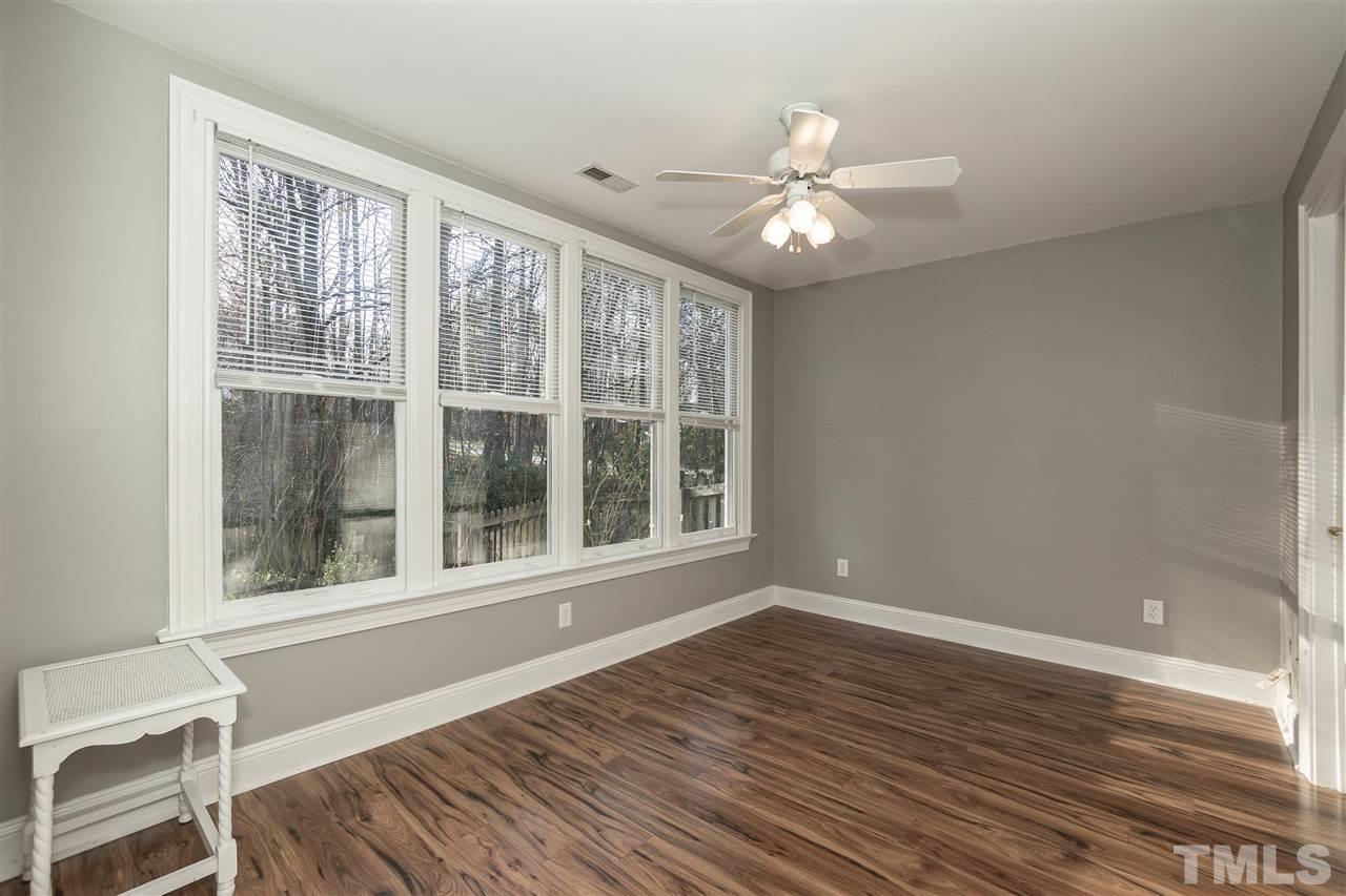 8704 Old Tom Way Raleigh, NC 27613 - Photo 22 of 30 a view of an empty room with wooden floor and a window