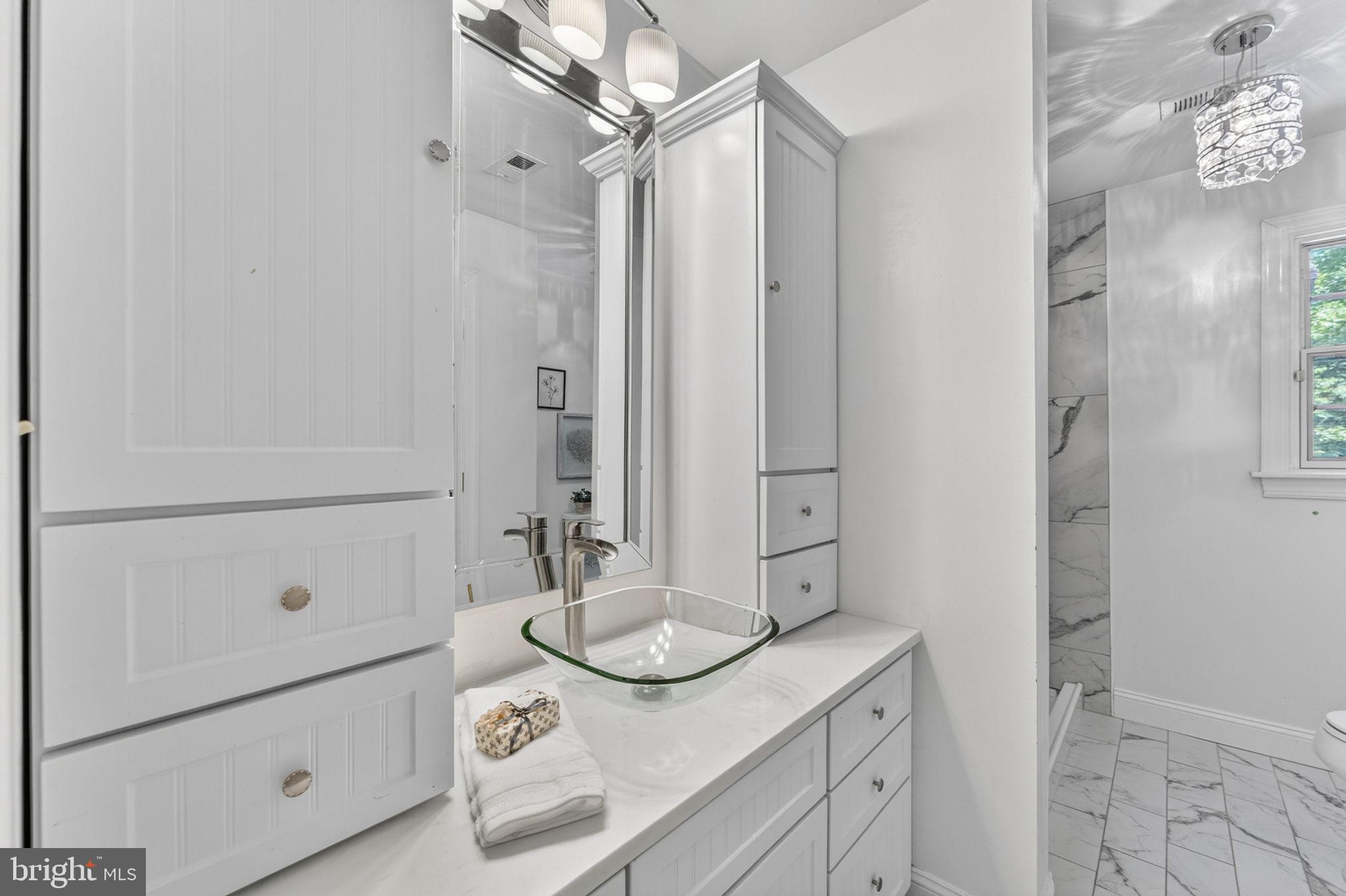 4531 Den Haag Road Warrenton, VA 20187 - Photo 54 of 103 a bathroom with a granite countertop sink a mirror and shower