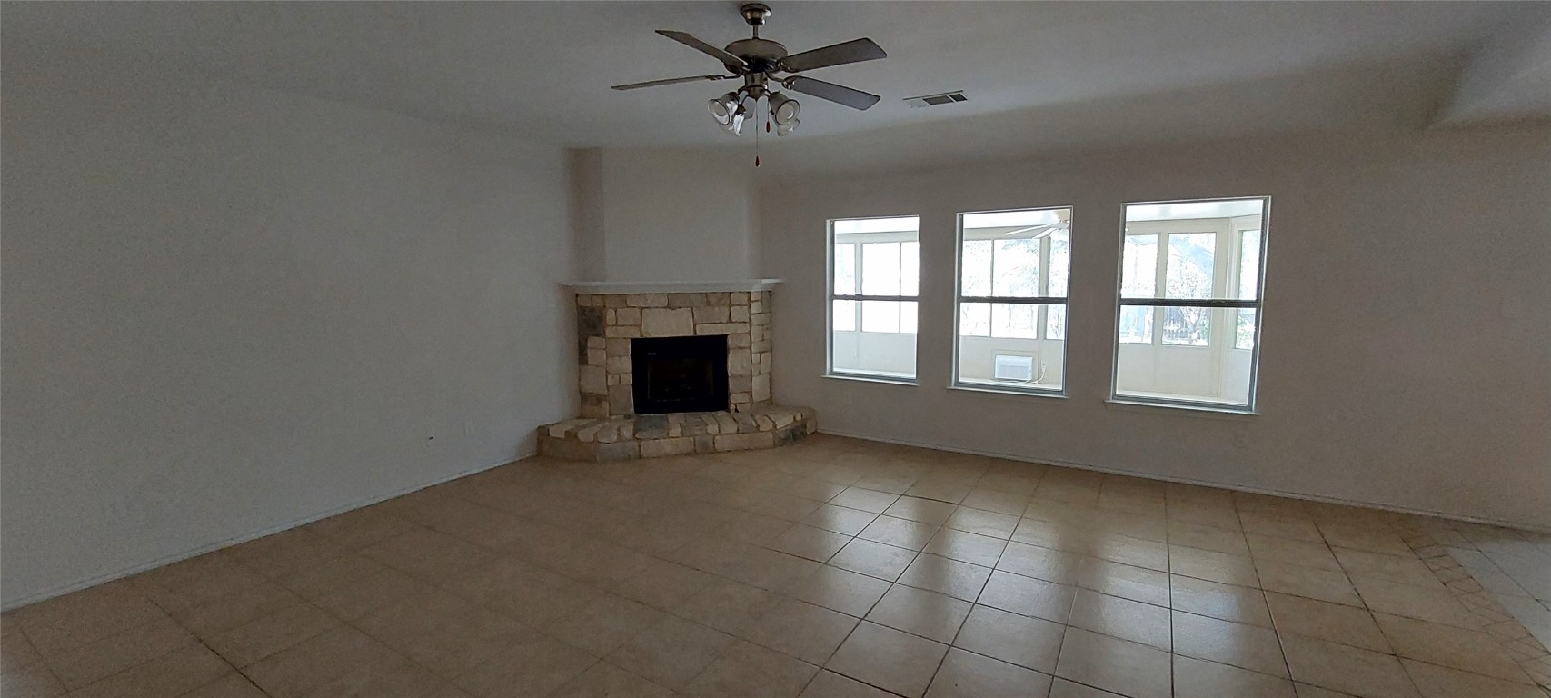 4 Memory Lane Wimberley, TX 78676 - Photo 4 of 20 a view of an empty room with chandelier fan and fire place