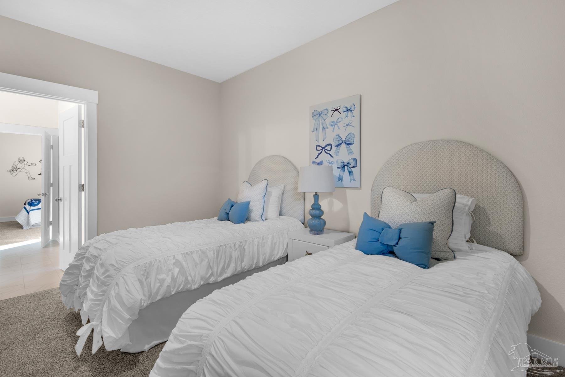 5912 Greenfield Street Pace, FL 32571 - Photo 13 of 47 a bedroom with two beds and a painting on the wall