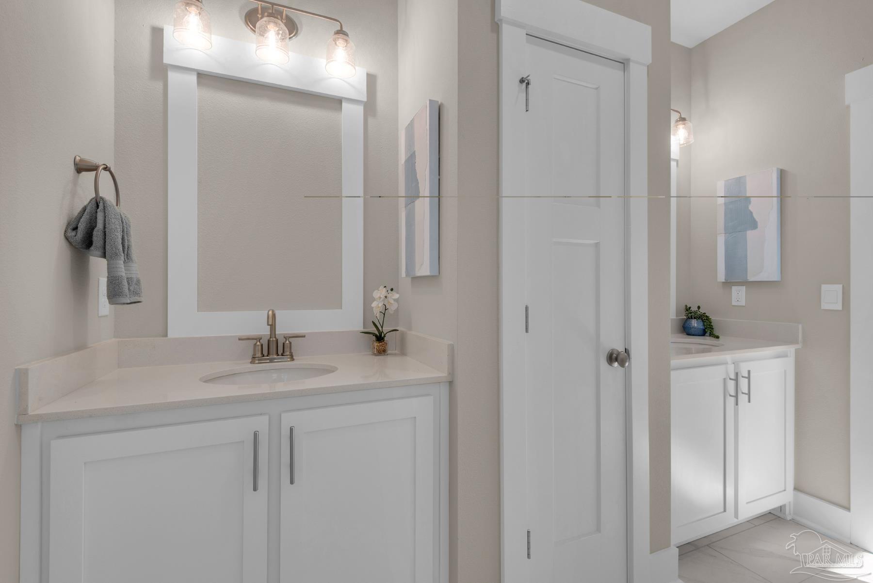 5912 Greenfield Street Pace, FL 32571 - Photo 14 of 47 a bathroom with a granite countertop sink and a mirror