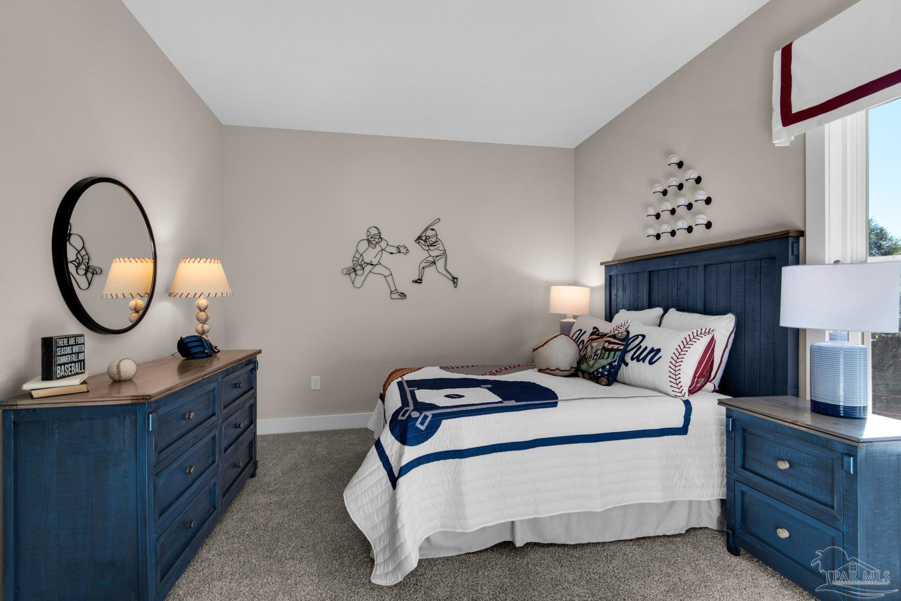 5912 Greenfield Street Pace, FL 32571 - Photo 16 of 47 a bed room with a bed and a mirror