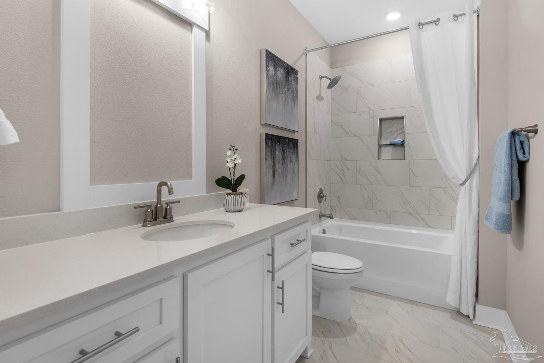 5912 Greenfield Street Pace, FL 32571 - Photo 21 of 47 a bathroom with a granite countertop sink toilet and shower