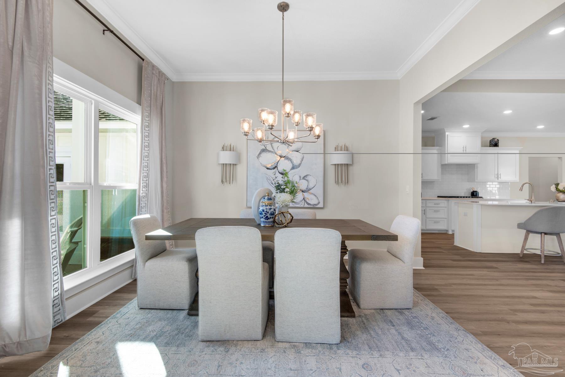 5912 Greenfield Street Pace, FL 32571 - Photo 25 of 47 a dining room with furniture a chandelier and wooden floor