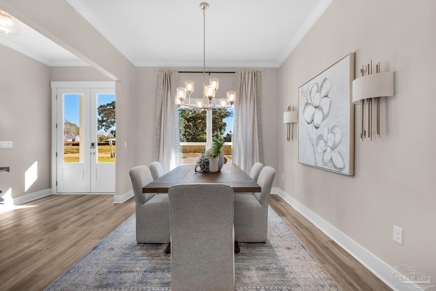 5912 Greenfield Street Pace, FL 32571 - Photo 26 of 47 a view of a dining room with furniture window and wooden floor