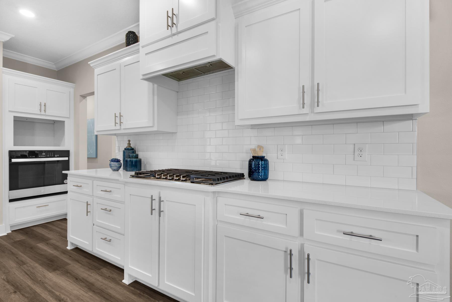 5912 Greenfield Street Pace, FL 32571 - Photo 31 of 47 a kitchen with white cabinets and white appliances