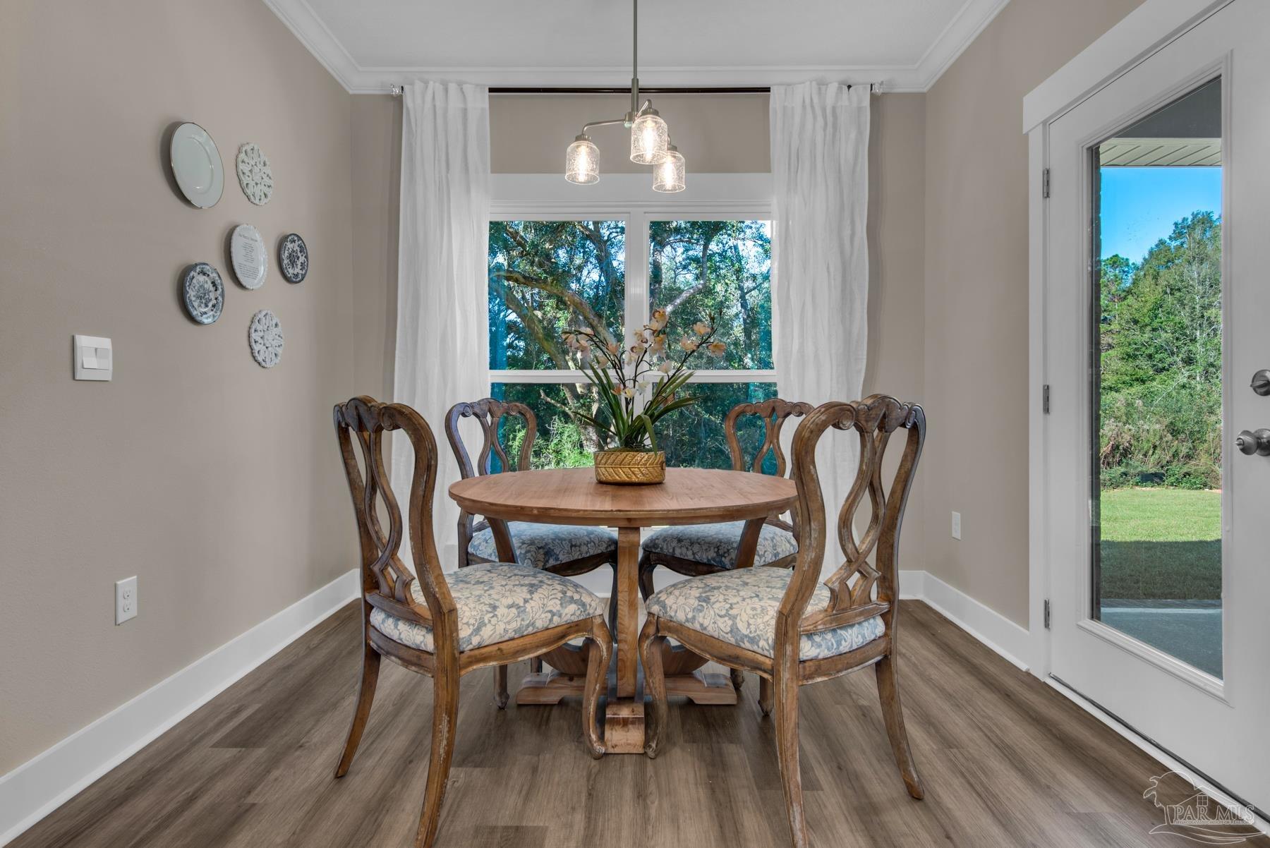 5912 Greenfield Street Pace, FL 32571 - Photo 36 of 47 a view of a dining room with furniture window and outside view