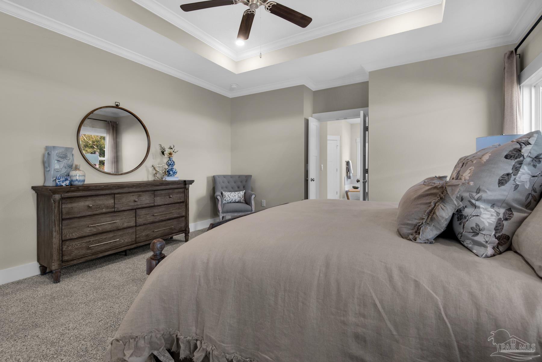 5912 Greenfield Street Pace, FL 32571 - Photo 40 of 47 a bedroom with a bed and a chandelier