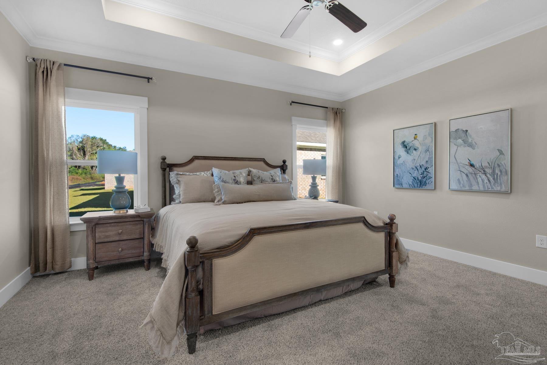 5912 Greenfield Street Pace, FL 32571 - Photo 41 of 47 a bed sitting in a bedroom next to a window