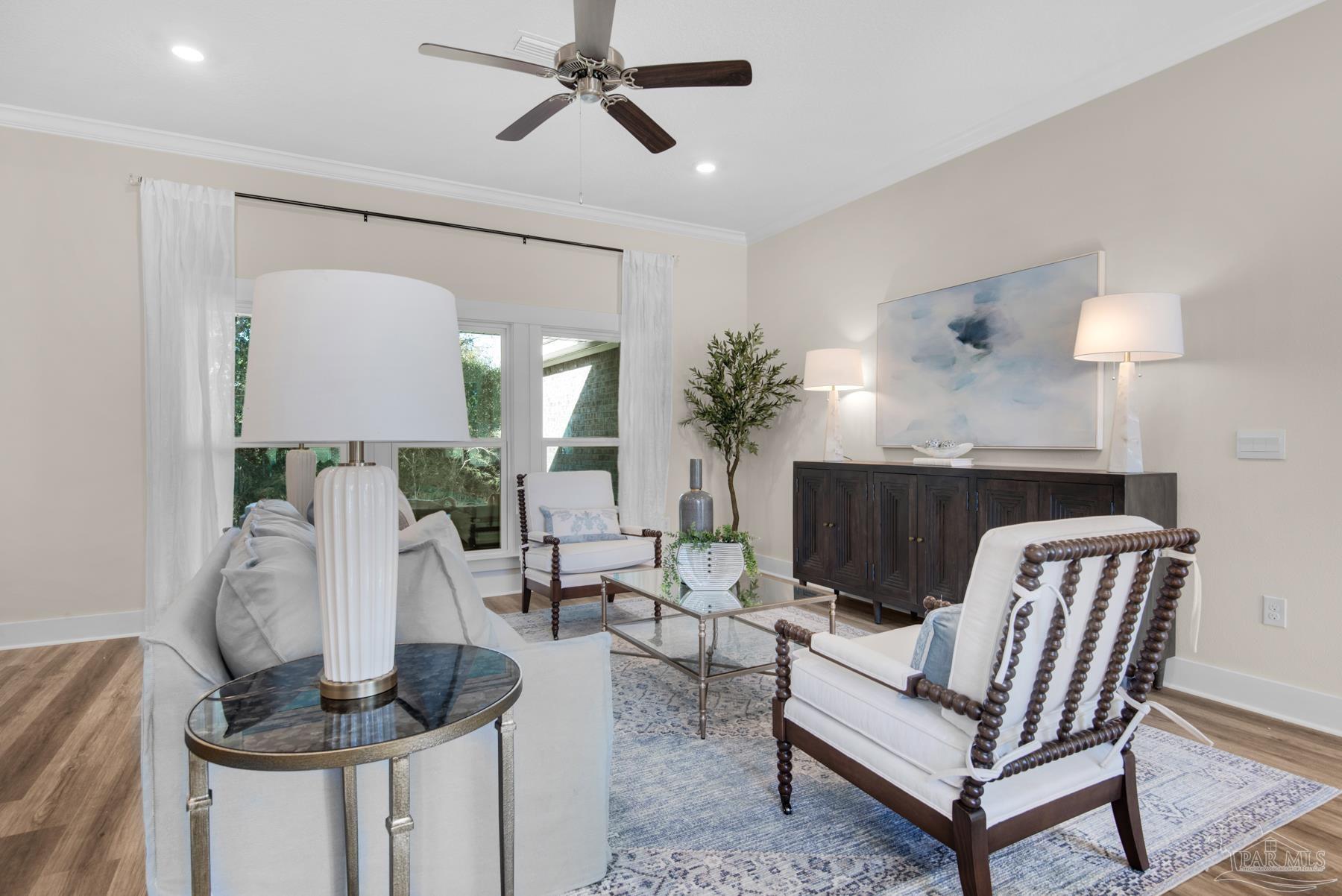 5912 Greenfield Street Pace, FL 32571 - Photo 7 of 47 a living room with furniture and a wooden floor
