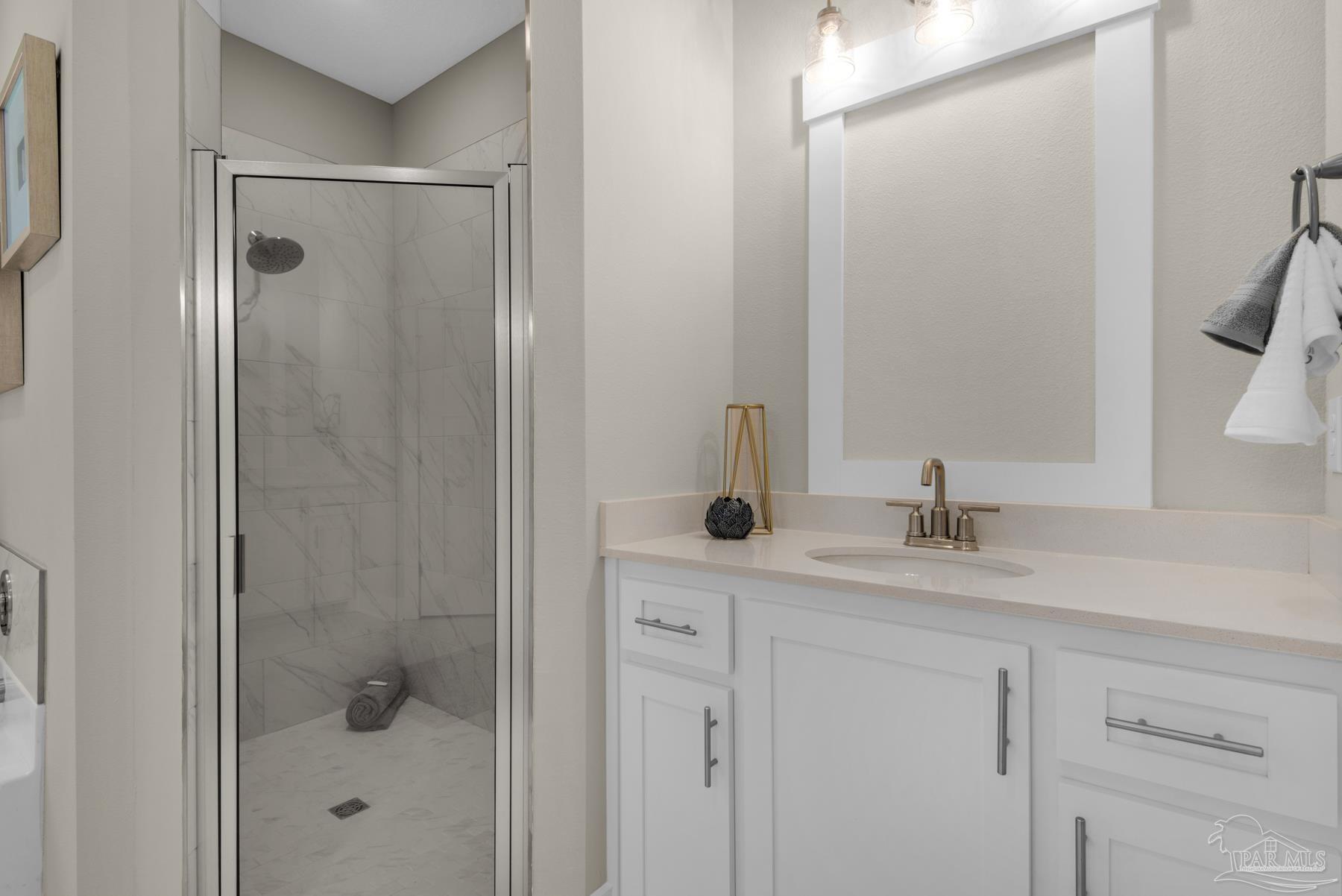 5912 Greenfield Street Pace, FL 32571 - Photo 9 of 47 a bathroom with a shower sink and mirror