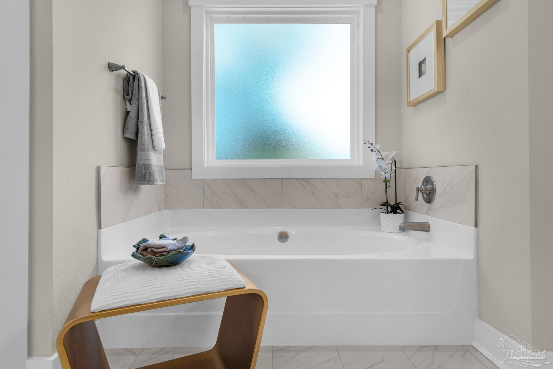 5912 Greenfield Street Pace, FL 32571 - Photo 10 of 47 a bathroom with a tub sink and window