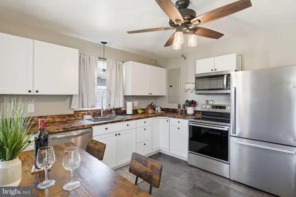 a kitchen with a sink stove and white stainless steel appliances