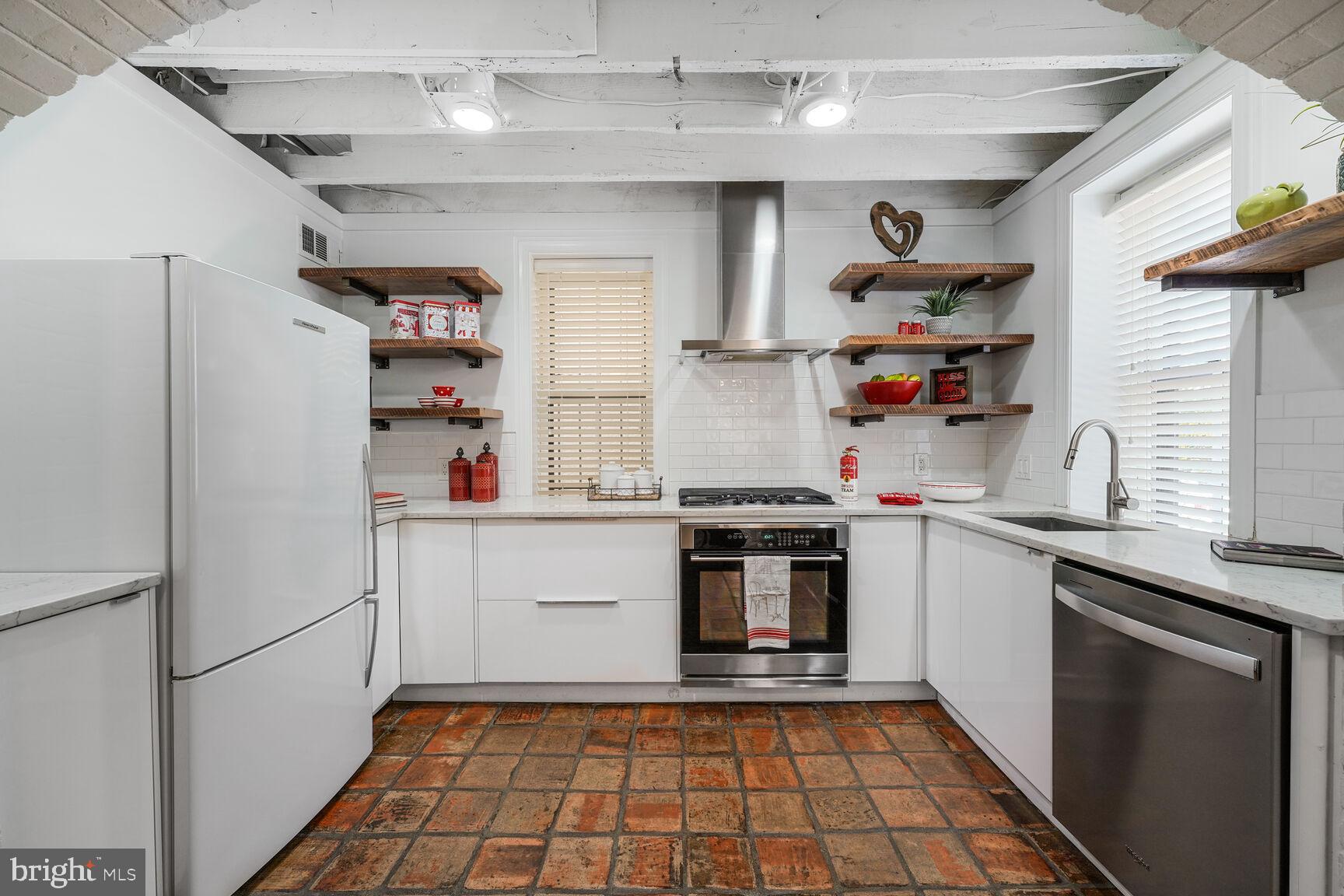 252 10th Street Northeast Washington, DC 20002 - Photo 11 of 31 a kitchen with stainless steel appliances a refrigerator and a sink