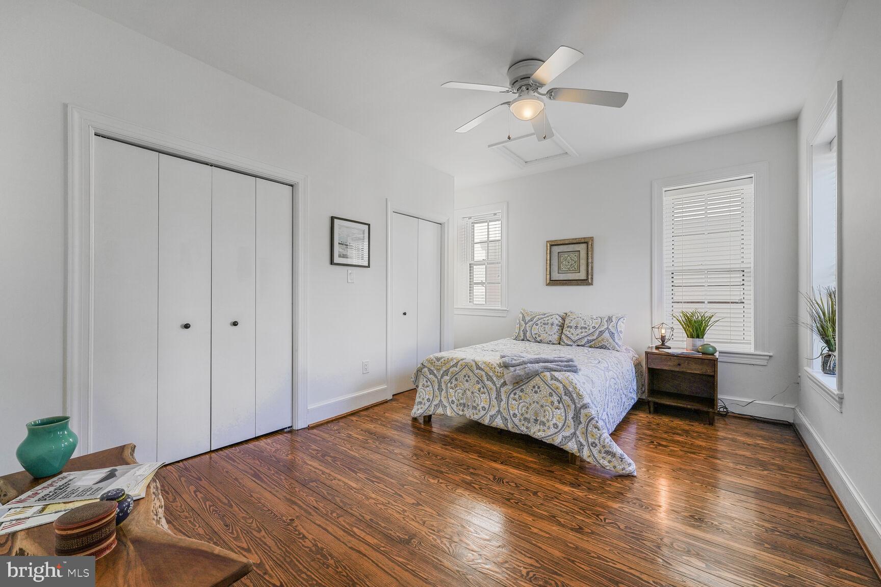 252 10th Street Northeast Washington, DC 20002 - Photo 15 of 31 a bedroom with a bed chandelier and a window