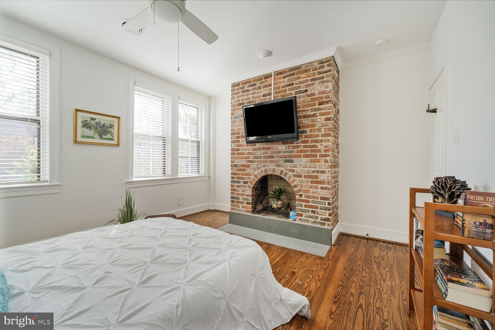 252 10th Street Northeast Washington, DC 20002 - Photo 17 of 31 a bedroom with a bed and a fireplace