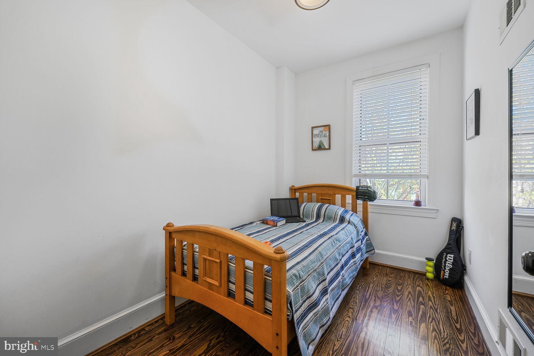252 10th Street Northeast Washington, DC 20002 - Photo 18 of 31 a bedroom with a bed and a window
