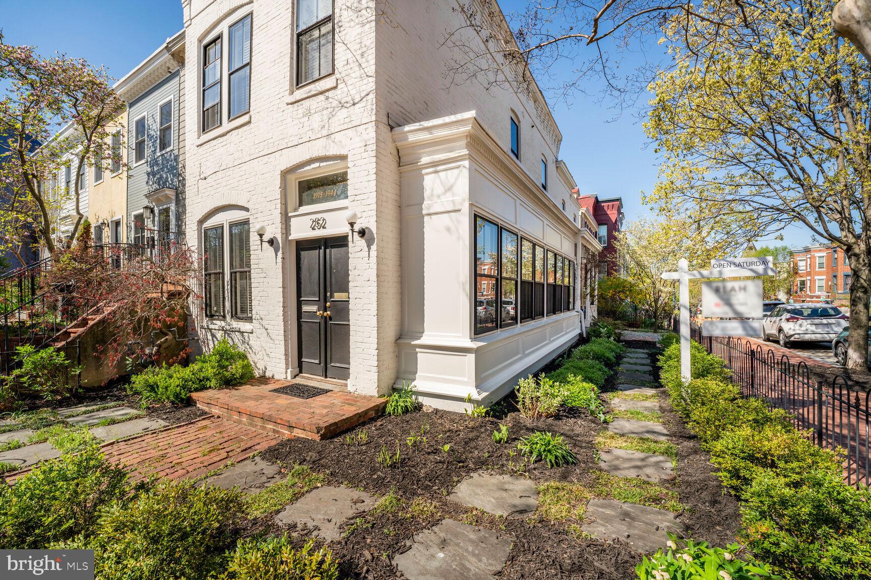 252 10th Street Northeast Washington, DC 20002 - Photo 2 of 31 a view of a house with a small yard and flower plants